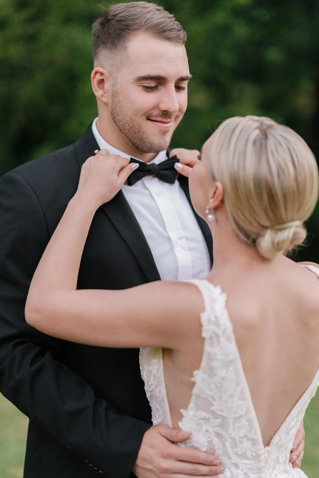 Groom adjusting his bowtie beside the bride, Pretoria wedding